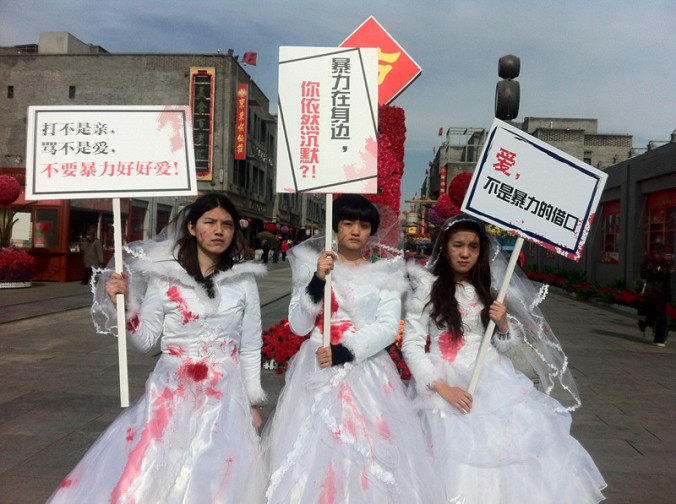Chinese feminists protesting against domestic violence in blood spattered bridal gowns
